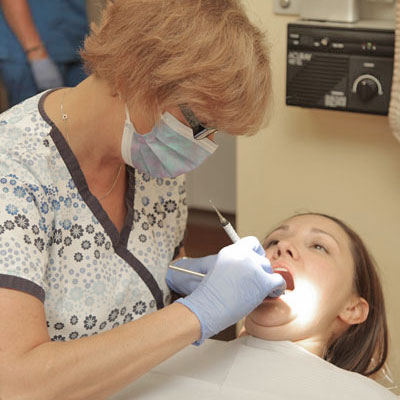 Dr. Tartaglione's staff member performs a periodontal dentistry procedure.