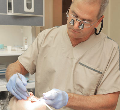 Dr. Tartaglione performing a tooth extraction on a patient in Mantua, NJ.